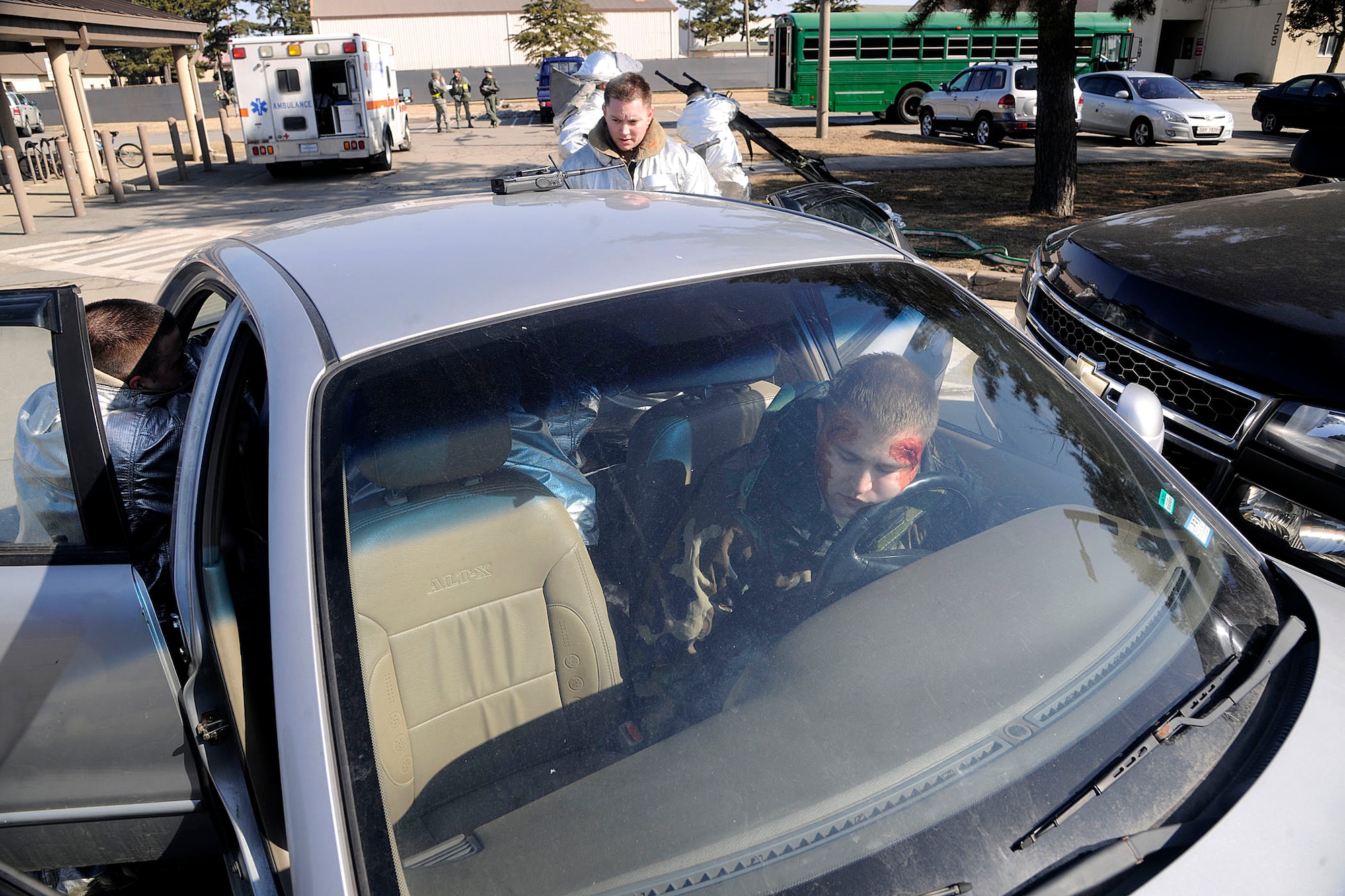 Firefighters from the 8th Civil Engineer Squadron, examines role players of a simulated car crash during exercise Beverly Bulldog 12-01 at Kunsan Air Base, Republic of Korea Jan. 30, 2012. It's the first Peninsula Operational Readiness Exercise of the year to test the Wolf Pack's ability to execute combat operations, receive follow-on forces, defend the base, and take the fight north. (U.S. Air Force photo by Staff Sgt. Rasheen Douglas/Released)