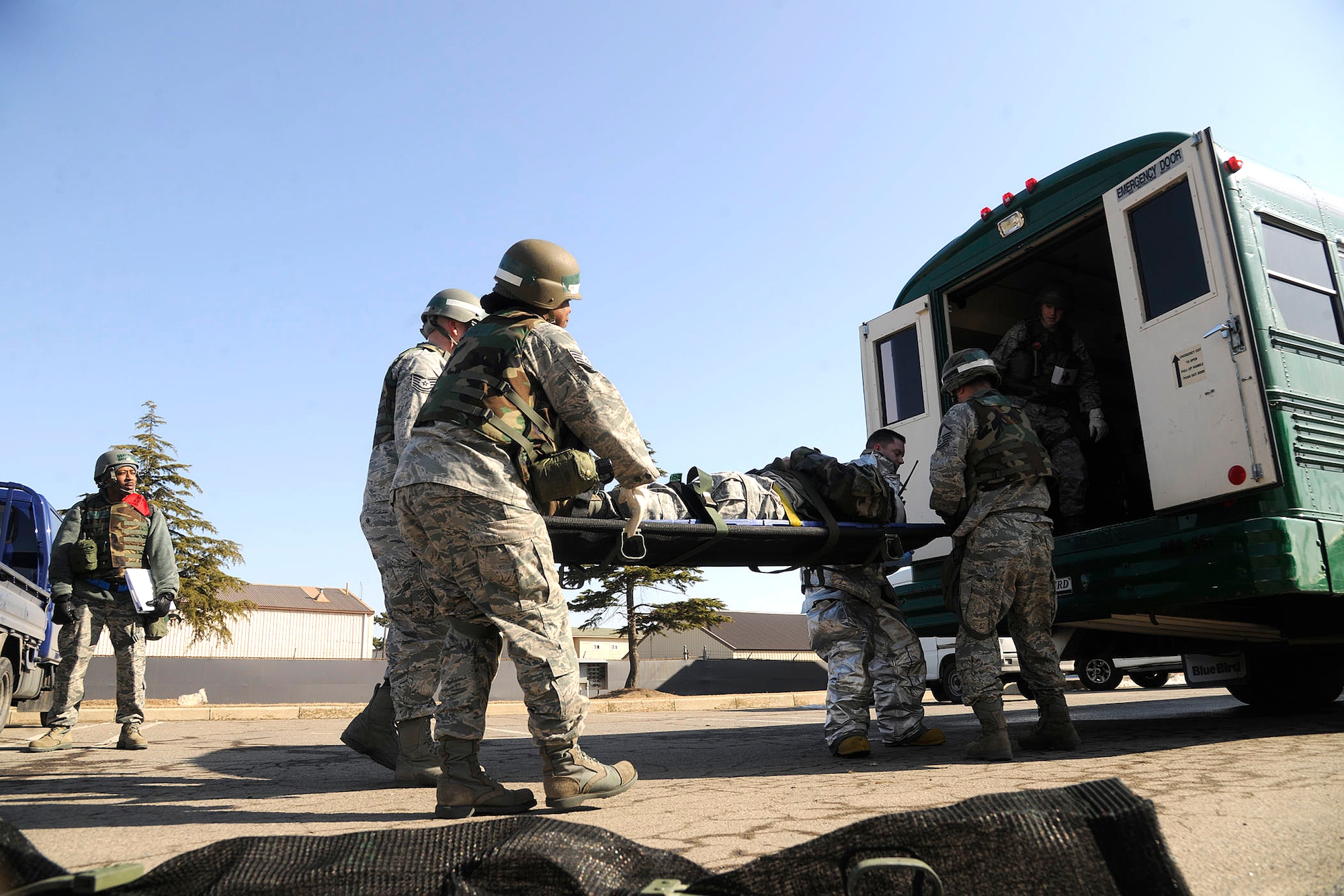 8th Medical Group members load a role player onto a bus after a simulated car crash during Beverly Bulldog 12-01 at Kunsan Air Base, Republic of Korea Jan. 30, 2012. It's the first Peninsula Operational Readiness Exercise of the year to test the Wolf Pack's ability to execute combat operations, receive follow-on forces, defend the base, and take the fight north. (U.S. Air Force photo by Staff Sgt. Rasheen Douglas/Released)