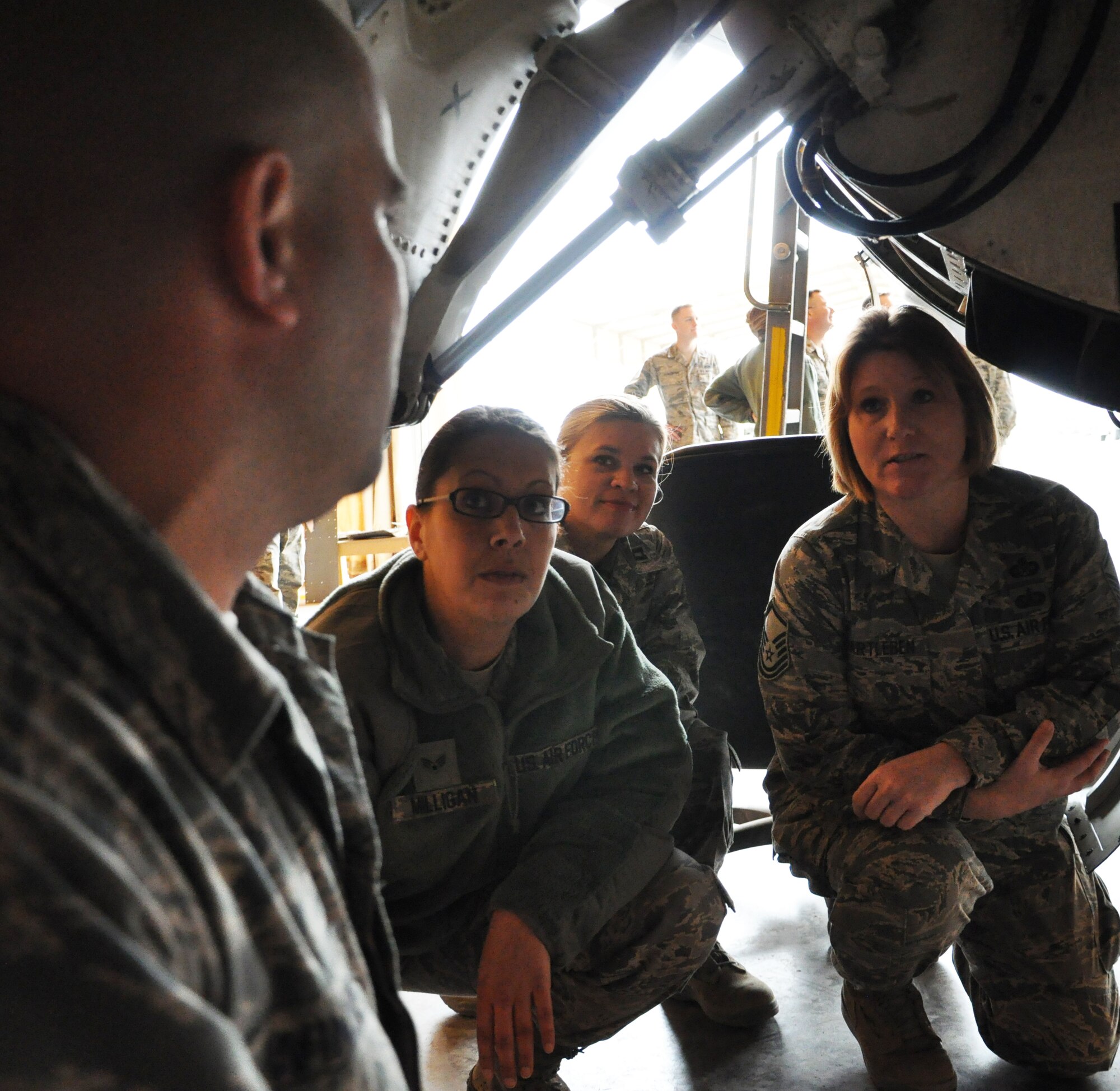 Senior Airman Kindra Milligan, Capt. Nicole Padgett and Master Sgt. Amy Hartleben, 332nd Air Expeditionary Wing staff agency members, get a close look at a landing gear on an F-16 going through phase Jan. 31, 2012 at an undisclosed location in Southwest Asia. So far, 332nd Expeditionary Maintenance Squadron maintainers have performed 17 phase inspections at this location. Milligan is deployed from Moody Air Force Base, Ga., and is a native of Oklahoma City. Padgett is deployed from Ramstein Air Base, Germany and is a native of Green River, Wyo. Hartlebeen is deployed from Andrews Air Force Base, Md., and is a native of White Bear Lake, Minn. (photo by Senior Airman Melanie Holochwost)