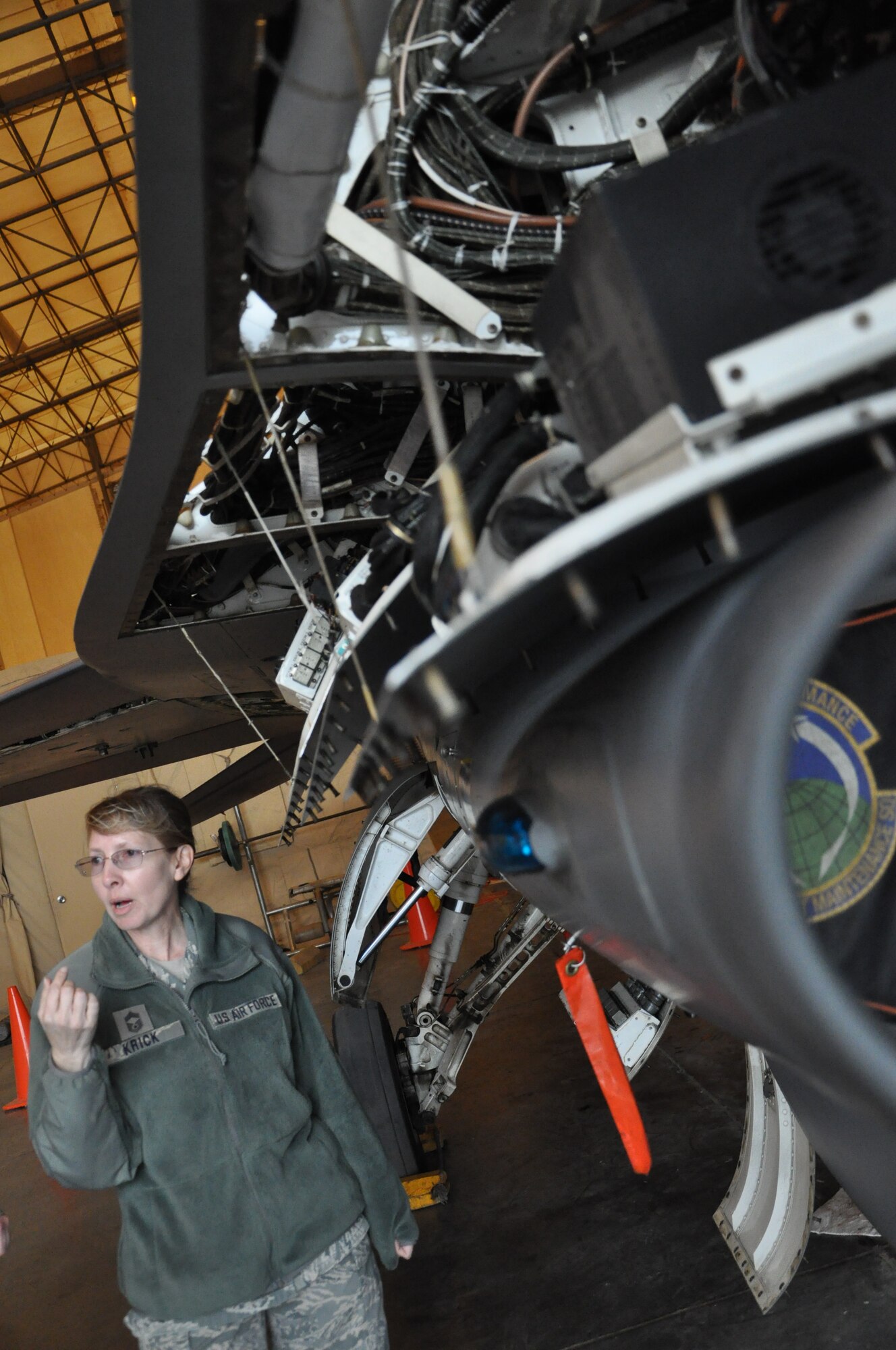 Chief Master Sgt. Barbara Krick, 332nd Expeditionary Maintenance Squadron, explains the F-16 phase process, which is a thorough inspection that occurs every 400 flying hours, to wing staff personnel Jan. 31, 2012 at an undisclosed location in Southwest Asia. According to Krick, panels are completely removed in phase so the entire jet can be inspected. Krick is deployed from Holloman Air Force Base, N.M., and is a native of Eagle River, Wis. (photo by Senior Airman Melanie Holochwost)