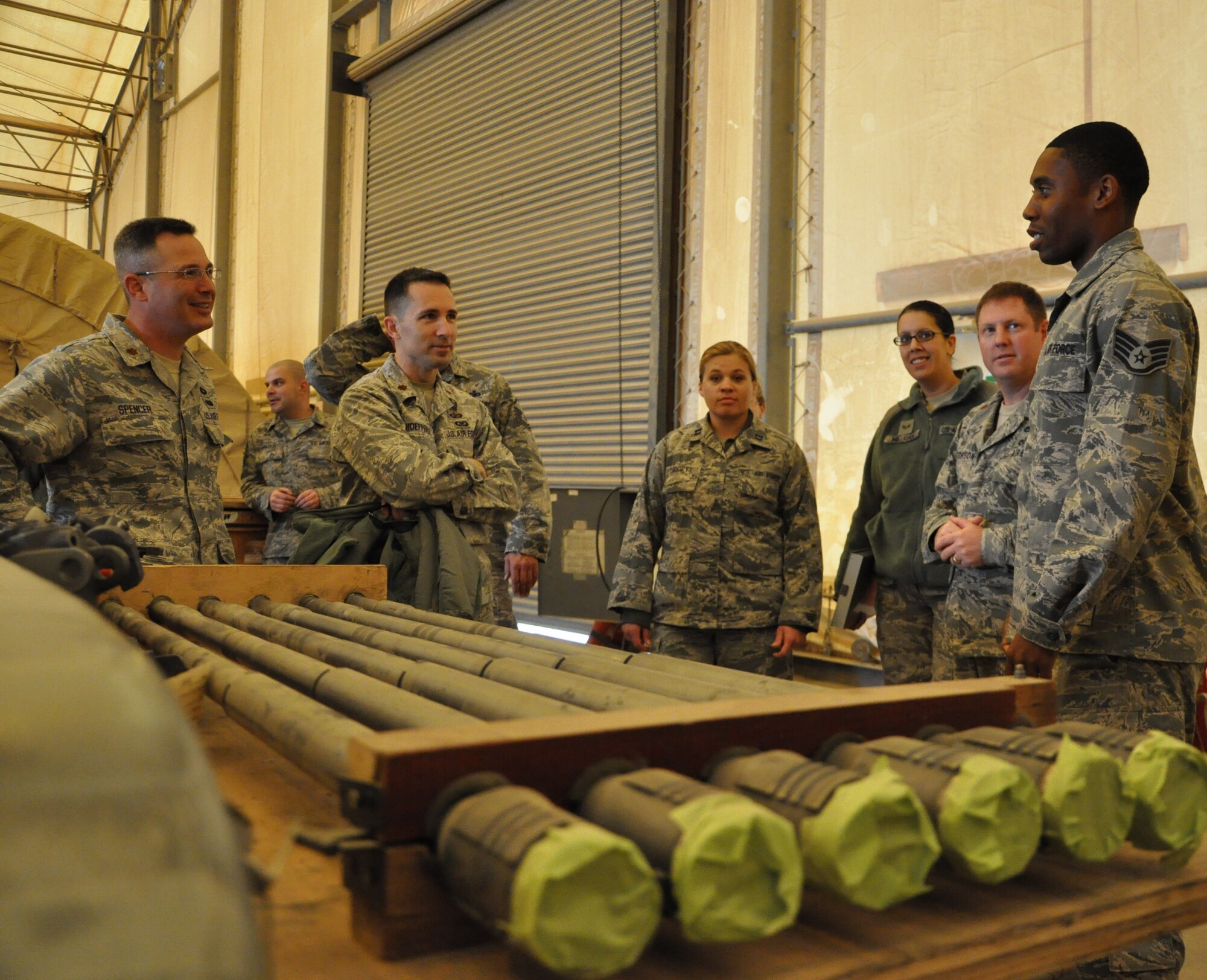 Staff Sgt. David Barnett, 332nd Expeditionary Maintenance Squadron, explains how weapons are connected to F-16s during a maintenance tour Jan. 31, 2012 at an undisclosed location in Southwest Asia. During the two-hour tour, maintenance personnel taught wing staff agency members about different aspects of their jobs including phase, weapons, sheet metal, egress and more. Barnett is deployed from Shaw Air Force Base, S.C., and is a native of Stone Mountain, Ga. (photo by Senior Airman Melanie Holochwost)