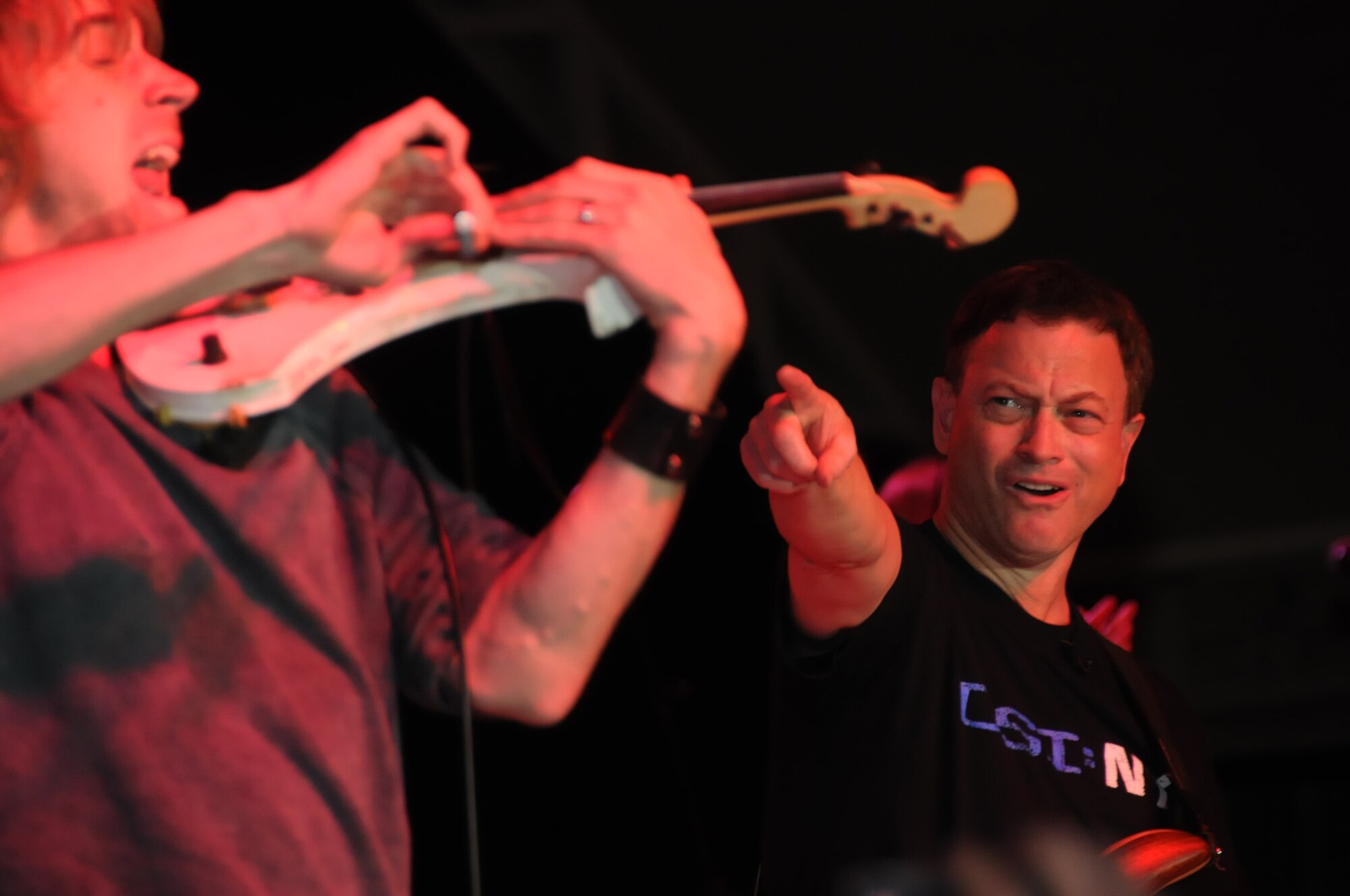SOUTHWEST ASIA -- Dan Myers plays the violin alongside bass guitarist and Emmy/Golden Globe winning actor Gary Sinise in an undisclosed location in Southwest Asia on Jan. 28, 2012. Sinise and the Lt. Dan Band have performed numerous concerts around the world to show their support to members of the U.S. military. (U.S. Air Force photo by Staff Sgt. James Lieth/Released)