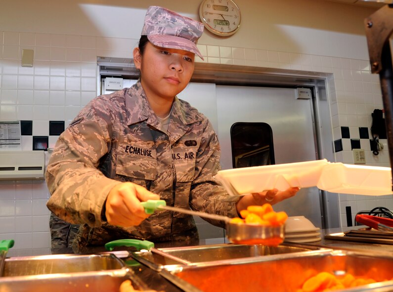 MISAWA AIR BASE, Japan -- Airman 1st Class Eileen Echaluse, 35th Force Support Squadron food service apprentice, scoops cooked carrots for a customer at Grissom Dining Facility here, Jan 26. The DFAC has a variety of meal choices that include fresh fruits and vegetables and an open salad bar. (U.S. Air Force photo/Airman 1st Class Kaleb Snay)
