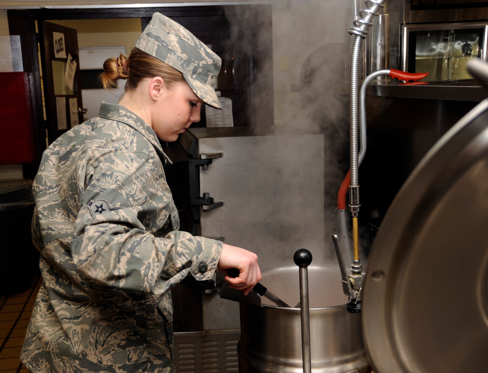 MISAWA AIR BASE, Japan -- Airman 1st Class Katie Young, 35th Force Support Squadron food service apprentice, stirs boiling soup at Grissom Dining Facility here, Jan. 26. More than 600 meals are served each day at the DFAC. (U.S. Air Force photo/Airman 1st Class Kaleb Snay)