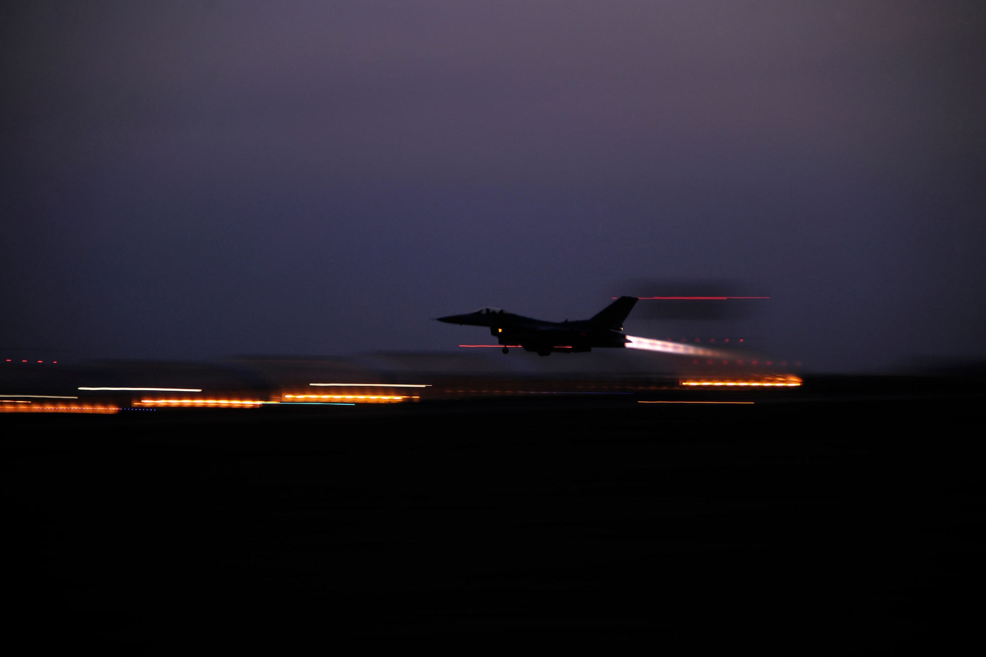 An F-16 Fighting Falcon launches at dawn at Kunsan Air Base, Republic of Korea, during a Peninsula Operational Readiness Exercise Jan. 31, 2012.  PENOREs ensure Wolf Pack members are capable of performing their duties in wartime conditions. (U.S. Air Force photo by Staff Sgt. Rasheen A. Douglas/Released)