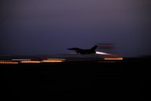 An F-16 Fighting Falcon launches at dawn at Kunsan Air Base, Republic of Korea, during a Peninsula Operational Readiness Exercise Jan. 31, 2012.  PENOREs ensure Wolf Pack members are capable of performing their duties in wartime conditions. (U.S. Air Force photo by Staff Sgt. Rasheen A. Douglas/Released)