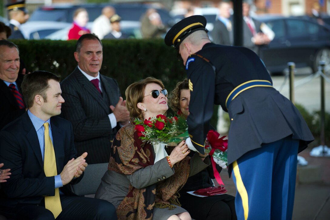 Beth Chiarelli, wife of Army Gen. Peter W. Chiarelli, receives flowers during her husband's retirement ceremony on Joint Base Myer-Henderson Hall in Arlington, Va., Jan. 31, 2012.