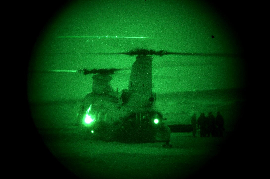 Marines wait outside a CH-46 Sea Knight helicopter during a night helocast training exercise at Camp Pendleton, Calif., Feb. 1. Marines from Company A, 1st Reconnaissance Battalion, 1st Marine Division,  helocasted with Japanese Rangers from the Japanese Ground Self Defense Force, as part of Exercise Iron Fist 2012, a bilateral training exercise between the 15th Marine Expeditionary Unit and the JGSDF.