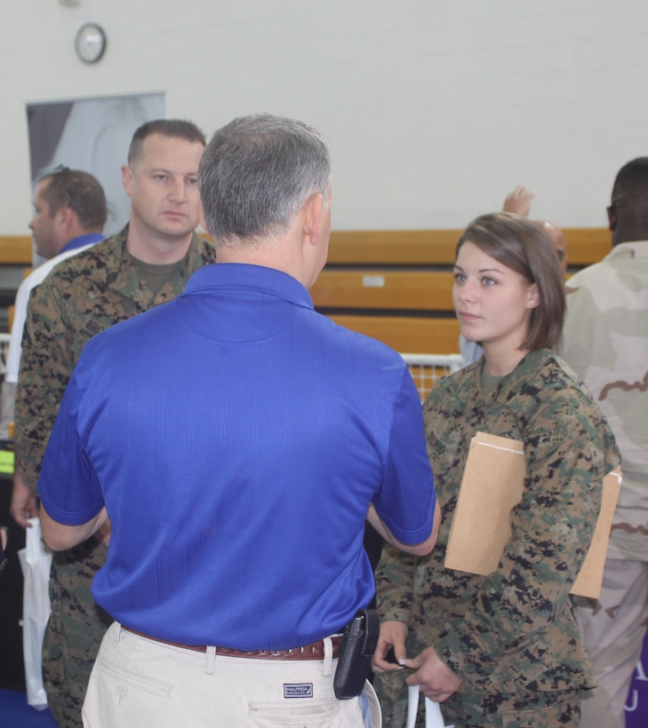 Jesse Solis, military relations at Brandman University talks with Gunnery Sgt. Jeff Brownfield, operations chief, Marine Aviation Logistics Squadron 39, Camp Pendleton, Calif. and Cpl. Alicia Diiorio, operations clerk, MALS 39 about the programs and opportunities the college offers. The career and education fair had 120 booths set up with information on military friendly organizations looking to help service members and their families meet their goals.