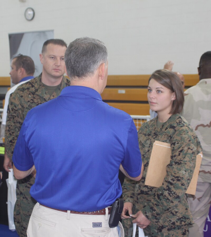 Jesse Solis, military relations at Brandman University talks with Gunnery Sgt. Jeff Brownfield, operations chief, Marine Aviation Logistics Squadron 39, Camp Pendleton, Calif. and Cpl. Alicia Diiorio, operations clerk, MALS 39 about the programs and opportunities the college offers. The career and education fair had 120 booths set up with information on military friendly organizations looking to help service members and their families meet their goals.