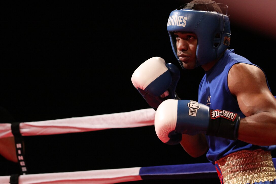 Lance Cpl. Johnathan C. Steele locks eyes with his opponent as he prepares to engage in his first round of the fight. Steele continues for a win at the Armed Forces Boxing Championship at Paige Fieldhouse Feb. 1.::r::::n::