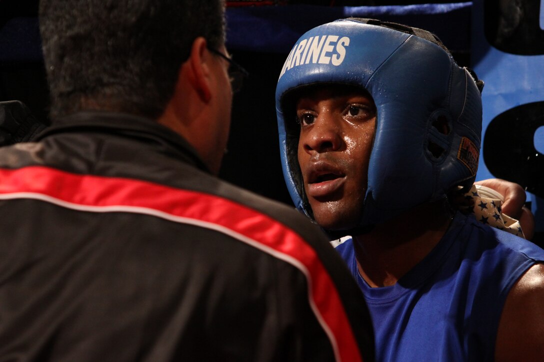 Lance Cpl. Johnathan Steele receives some words of encouragment from his corner before his final round of  the Amred Forces Boxing Championship at Paige Fieldhouse Feb. 1.::r::::n::::r::::n::