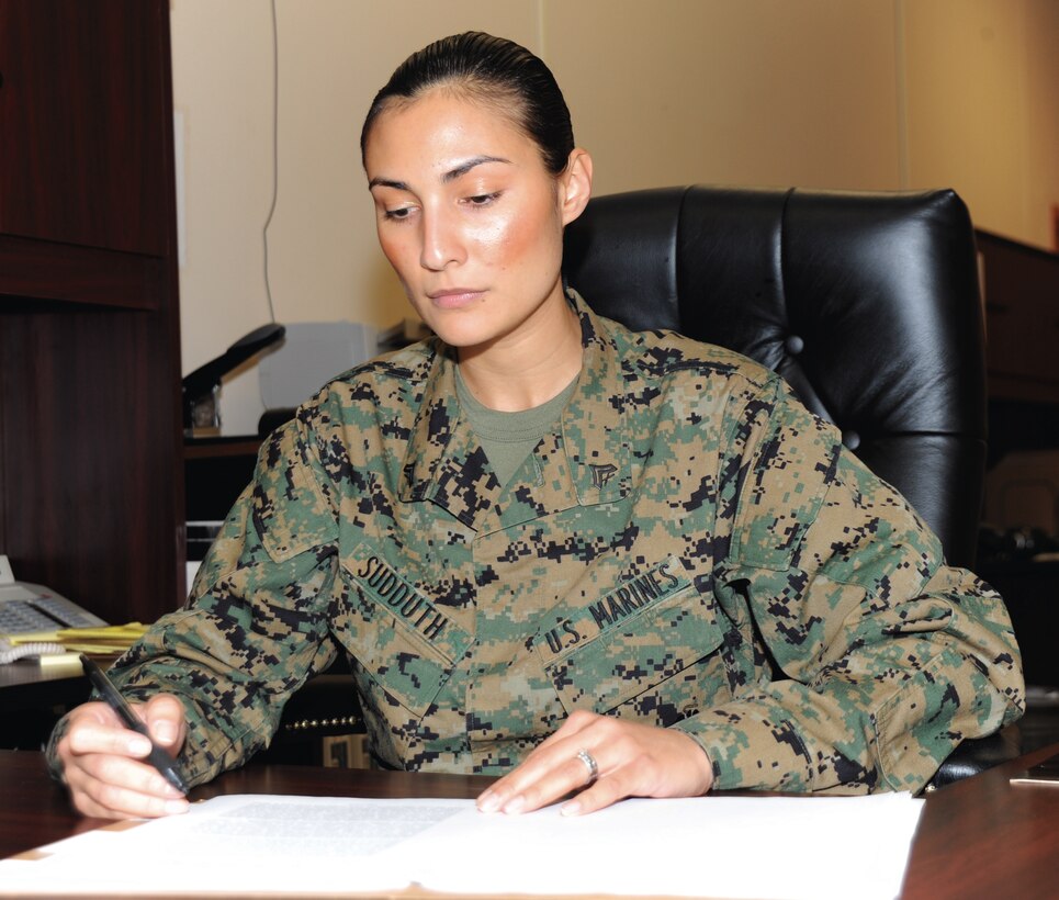 Cpl. JoAnna Sudduth, Office of the Staff Judge Advocate, reads over a will in her office, Friday. Sudduth will be meritoriously promoted to the rank of sergeant today.