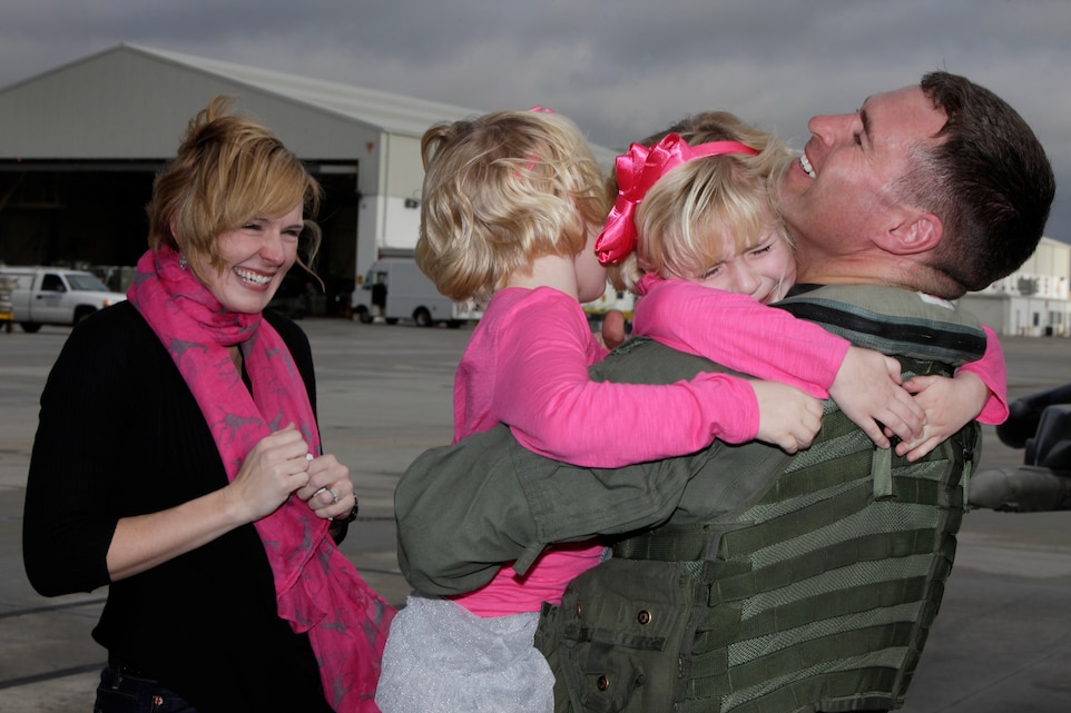 Maj. Michael Murphy, an AV-8B Harrier pilot with Marine Attack Squadron 231, takes hold of his two daughters, Elli and Annabel, after returning to Marine Corps Air Station Cherry Point Feb. 2, 2012, following a more than 10-month deployment at sea attached to the 22nd Marine Expeditionary Unit. To celebrate, the Murphy family is going on a Disney Cruise at the end of the month. "Back to the boat," said Murphy, "will be much more comfortable this time around though."