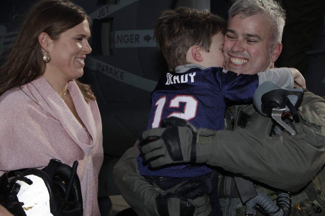 Maj. Ben Hutchins grips his 4-year-old son, Wyatt, Feb. 2, 2012, after returning from a more than 10-month deployment as the officer in charge for a Marine Attack Squadron 231 AV-8B Harrier detachment attached to the 22nd Marine Expeditionary Unit. Hutchins wife, Laura, said it was surreal to see her husband after being away for so long.