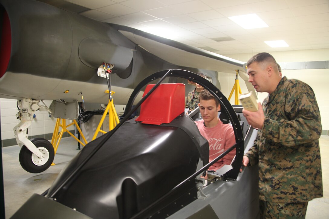 Gunnery Sgt. Jeremiah Francis, a Center for Naval Aviation Technical Training instructor who led students through the CNATT facility, teaches Shane Wilson, a junior at Havelock High School, and Kyle Sizemore, a senior at New Bern High School, about the AV-8B Harrier Feb. 2. Eighteen students from Craven County schools came to Marine Corps Air Station Cherry Point for a chance to follow Marines from various shops throughout the air station.