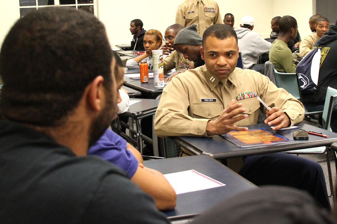 United States Marine Corps Capt. Travis Reeves, a comptroller at Marine Corps Recruit Depot Parris Island, S.C., mentors students during a leadership seminar at a meeting Feb. 2, 2012 for the Penn State Chapter of the National Society of Black Engineers. Reeves, along with several Marines from the Eastern Recruiting Region, spoke to the PSU chapter of the NSBE about leadership traits and opportunities to serve as a Marine Corps officer.