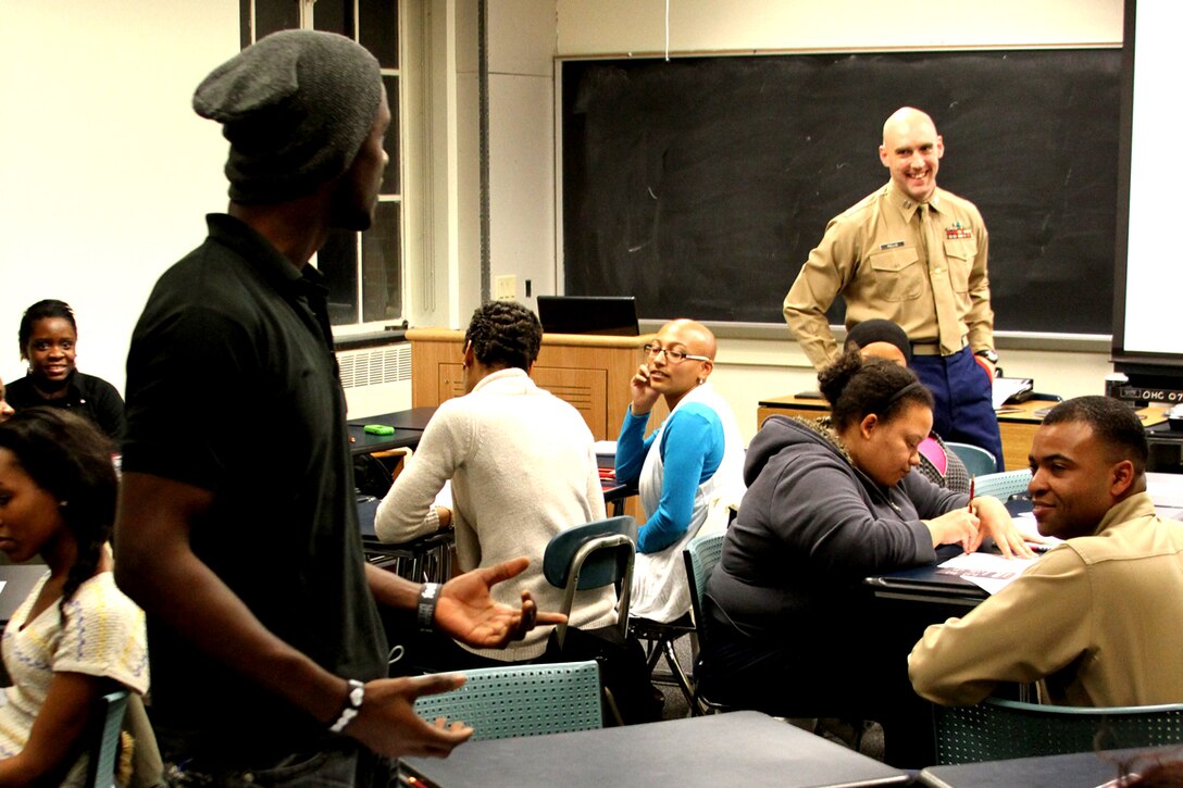 United States Marine Corps Capt, William Hollis, the officer selection officer for Recruiting Station Pittsburgh's Officer Selection Team State College responds to Jean-Pierre LaGuerre, 19, a sophomore mechanical engineering major from Nassau, Bahamas, leadership trait explanation during a leadership seminar at a meeting Feb. 2, 2012 for the Penn State Chapter of the National Society of Black Engineers. LaGuerre, along with more than 30 of his fellow chapter mates attended the seminar to learn more about Marine Corps leadership and opportunities to serve in the military as a Marine Corps officer.
