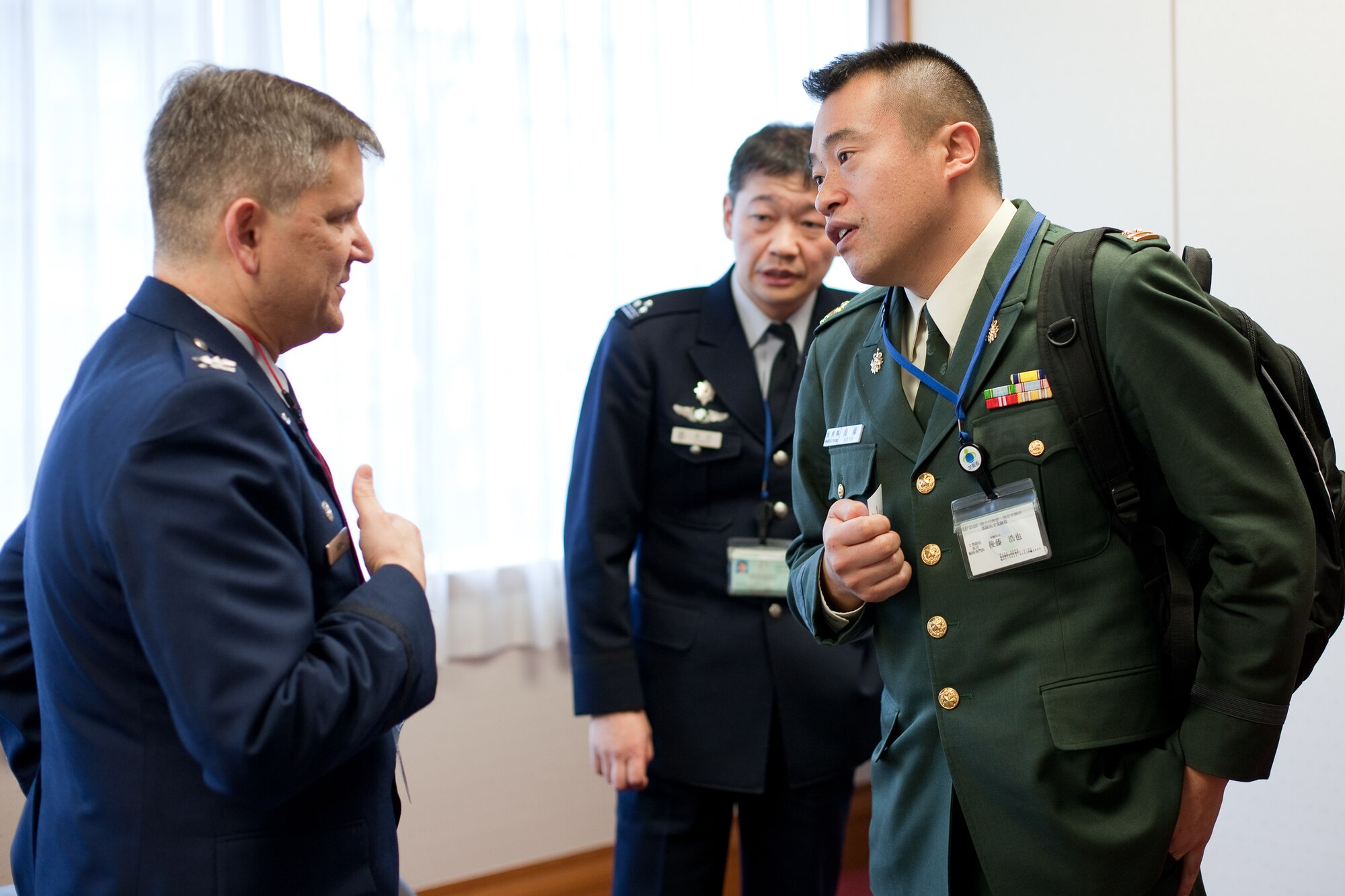TOKYO, Japan -- A member of the Japan Ground Self-Defense Force asks U.S. Air Force Col. Lee Harvis, 374th Medical Group commander, and U.S. Forces, Japan and Fifth Air Force surgeon, a question following his briefing at the Japanese Ministry of Defense in Tokyo, Japan, Feb.1, 2012. Harvis gave a a briefing on Yokota's medical response following the earthquake, tsunami, and Fukushima nuclear meltdown during Operation Tomodachi. (U.S. Air Force photo/Osakabe Yasuo)