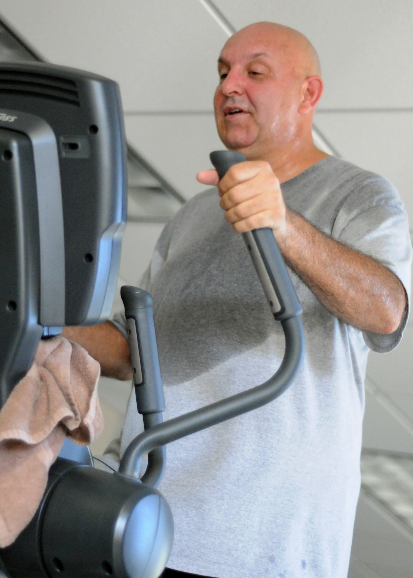 Master Sgt. John Wood of the 919th Logistics Readiness Squadron exercises on an elliptical machine in the fitness center at Duke Field, Fla. recently. The newly renovated facility is officially open and available for use daily from 5 a.m. to 11 p.m. by members assigned to Duke Field and the 7th Special Forces Group. (U.S. Air Force photo/Tech. Sgt. Cheryl Foster)