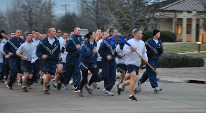 Members of the 9th Munitions Squadron run during a morning physical training formation at Beale Air Force Base, Calif., Feb. 1, 2012. The squadron is home to the Combat Ammunition Center training program. (U.S. Air Force photo by Staff Sgt. Robert M. Trujillo)
