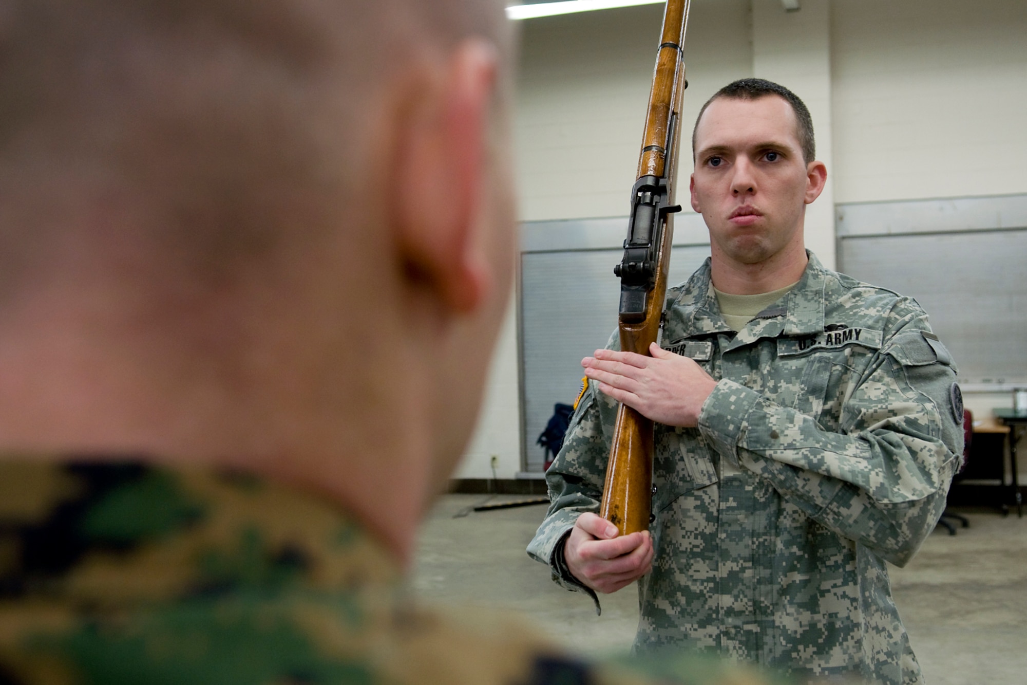 INDIANAPOLIS -- U.S. Army Reserve Sgt. 1st Class David Warder, right, synchronizes his rifle movements with U.S. Marine Corps Sgt. Joshua Bishop during a joint color guard training at the U.S. Army Reserve Center in Indianapolis Jan. 25. Warder and Bishop, along with six other servicemembers from around Indiana, will present the Colors at Super Bowl XLVI Feb. 5. (U.S. Air Force photo/Tech. Sgt. Mark R. W. Orders-Woempner)
