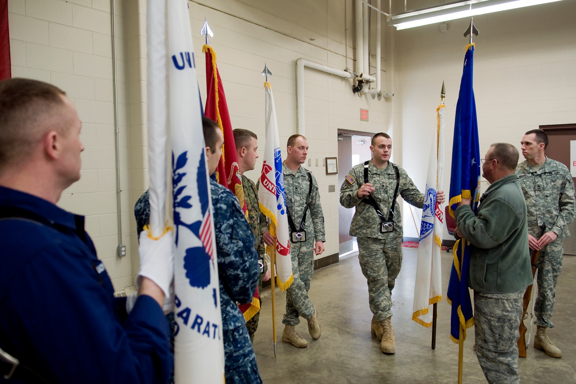 INDIANAPOLIS -- U.S. Army Reserve Staff Sgt. Austin Stoner, center, talks with U.S. Air Force Reserve Master Sgt. Geoff Spaulding about drill movements during a joint color guard training session at the U.S. Army Reserve Center Jan. 25. Eight servicemembers from units across the Hoosier heartland will take center field at Lucas Oil Stadium in Indianapolis to present the Colors during Super Bowl XLVI Feb. 5. (U.S. Air Force photo/Tech. Sgt. Mark R. W. Orders-Woempner)
