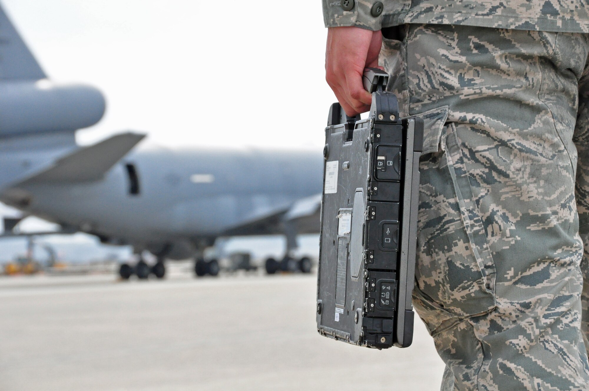 Senior Airman Anthony Mitchell, a 660th Aircraft Maintenance Squadron crew chief, prepares to use a laptop to work on a KC-10 Extender Jan.30, 2012, at Travis Air Force Base, Calif. On the flightline at Travis AFB, laptops have replaced the traditional technical order books maintainers used for decades. (U.S. Air Force photo/Staff Sgt. Patrick Harrower)