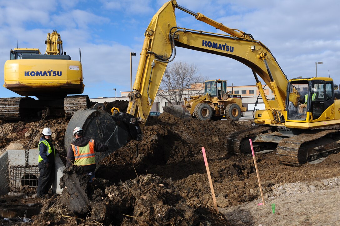 Civilian contractors from Quinn Construction excavate land to install new polyvinyl chloride waterlines on Ellsworth Air Force Base, S.D., Jan. 13, 2012. The construction team is scheduled to complete the building of an alternative water supply in early July. (U.S. Air Force photo by Airman 1st Class Zachary Hada/Released)
