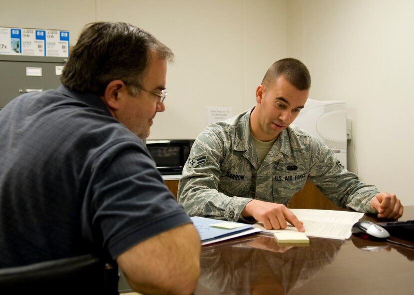 Airman 1st Class Ryan Darrow, 2nd Communications Squadron and base tax center volunteer, discusses tax information with Michael Good before filing his taxes on Barksdale Air Force Base, La., Feb. 1.  Volunteers are specifically trained on military tax law for base personnel with specific needs. (U.S. Air Force photo/Airman 1st Class Benjamin Gonsier)(RELEASED)