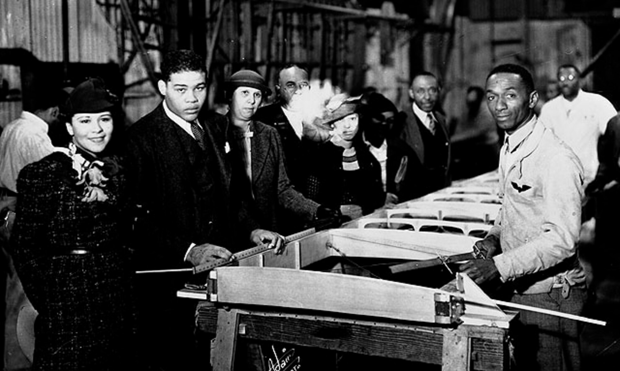 William J. Powell (right) with world boxing champ Joe Lewis at Powell's aircraft building company.