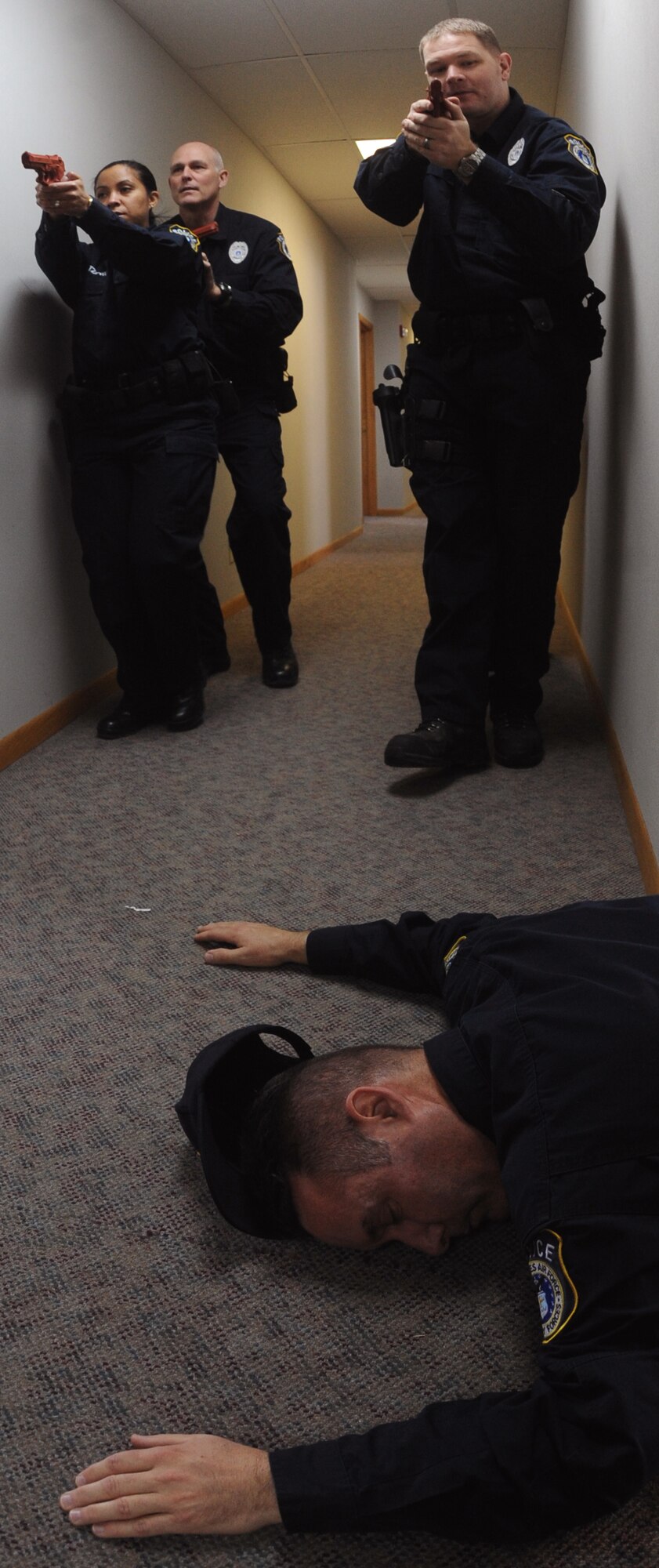 Civilian police officers of the 319th Security Forces Squadron look for insurgents and fatalities during an exercise on Grand Forks Air Force Base, N.D., Jan. 24, 2012. The officers work to complete their 2012 annual training requirements which include lethal, non-lethal, self aid buddy care, cardiopulmonary resuscitation and more during a two week time frame. (U.S. Air Force photo by Airman 1st Class Xavier Navarro)