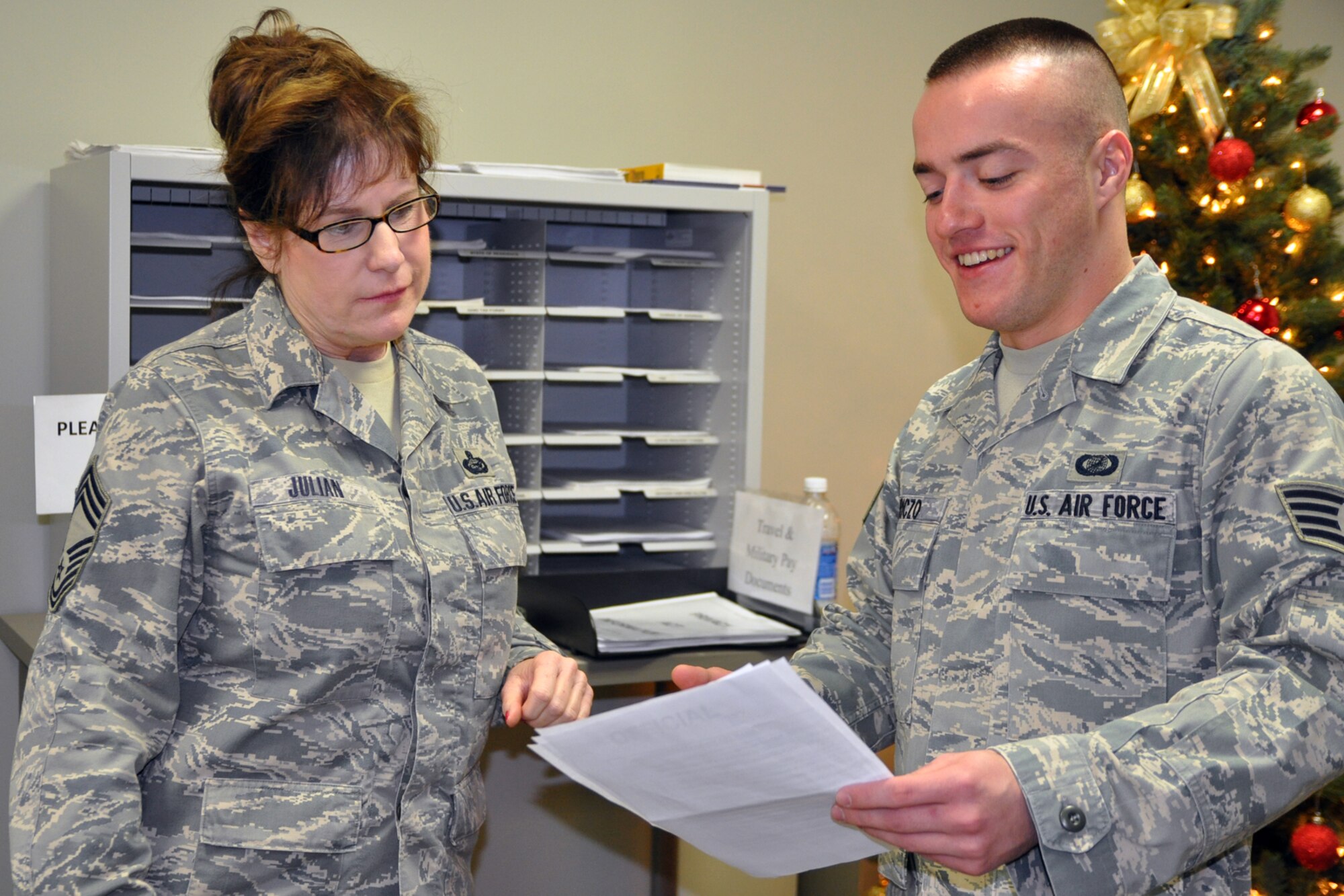 YOUNGSTOWN AIR RESERVE STATION, Ohio – Air Force Reserve Staff Sgt. Greg Hriczo (right), military pay supervisor with 910th Airlift Wing Financial Management, explains how to fill out part of a travel voucher to Chief Master Sgt. Mary Julian, Chief of Military Personnel Programs with 910th Airlift Wing Force Support Squadron, here Dec. 3, 2011. Hriczo was given the distinguished graduate award after completing Airman Leadership School in September. U.S. Air Force photo by Staff Sgt. Valerie Smock