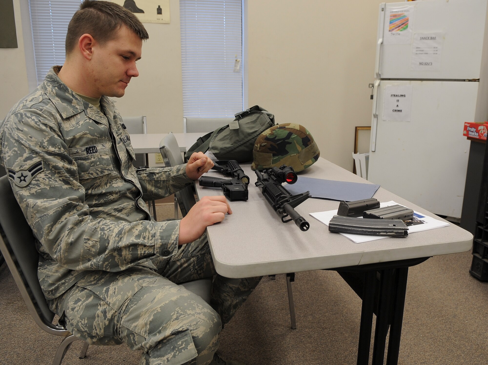 U.S. Air Force Airman 1st Class James Reed, 23rd Contracting Squadron contracting specialist, disassembles an M4 assault rifle during a Combat Arms Training and Maintenance class at Moody Air Force Base, Ga., Feb. 1, 2012. During CATM courses, instructors stress the importance of knowing the details of your weapon. (U.S. Air Force photo by Airman 1st Class Olivia Dominique/Released)