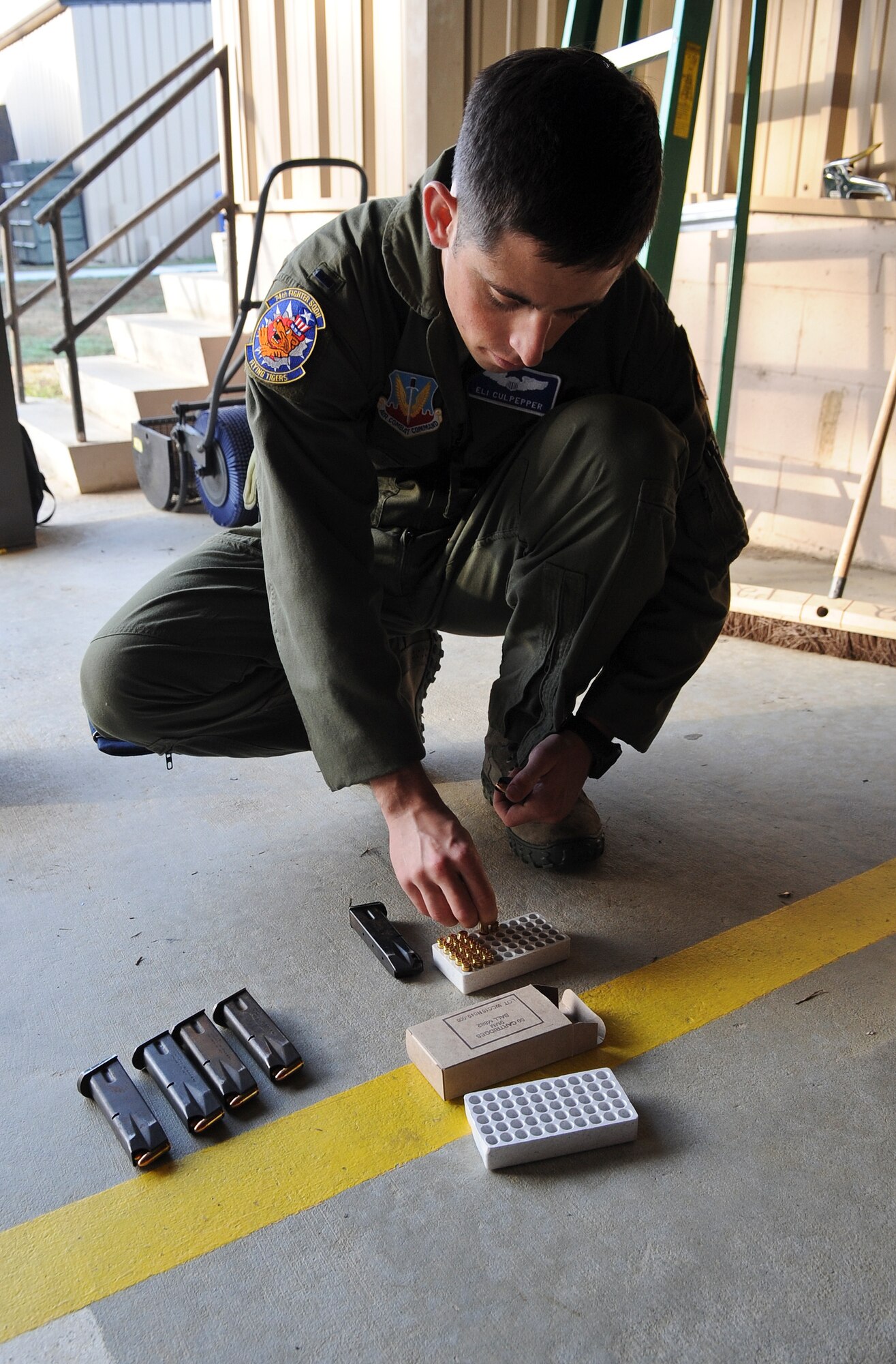 U.S. Air Force 1st Lt. Elijah Culpepper, 74th Fighter Squadron A-10C Thunderbolt II pilot, loads a magazine at the Combat Arms Training and Maintenance range at Moody Air Force Base, Ga., Feb. 1, 2012. Culpepper was in the process of qualifying for the Beretta M9 handgun. (U.S. Air Force photo by Airman 1st Class Olivia Dominique/Released)