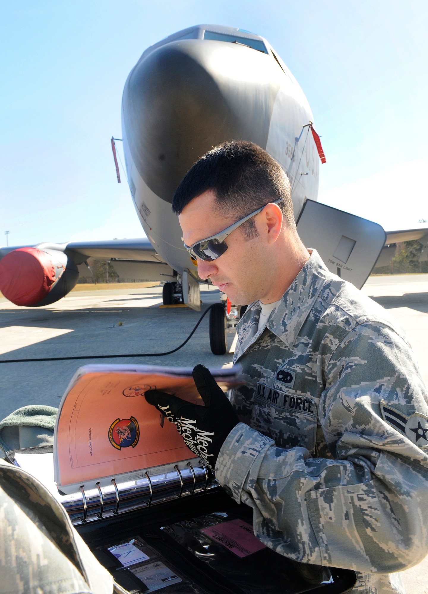 A1C Dustin Tatem notates servicing performed on one of the KC-135s here at Robins from MacDill AFB. U. S. Air Force photo by Sue Sapp