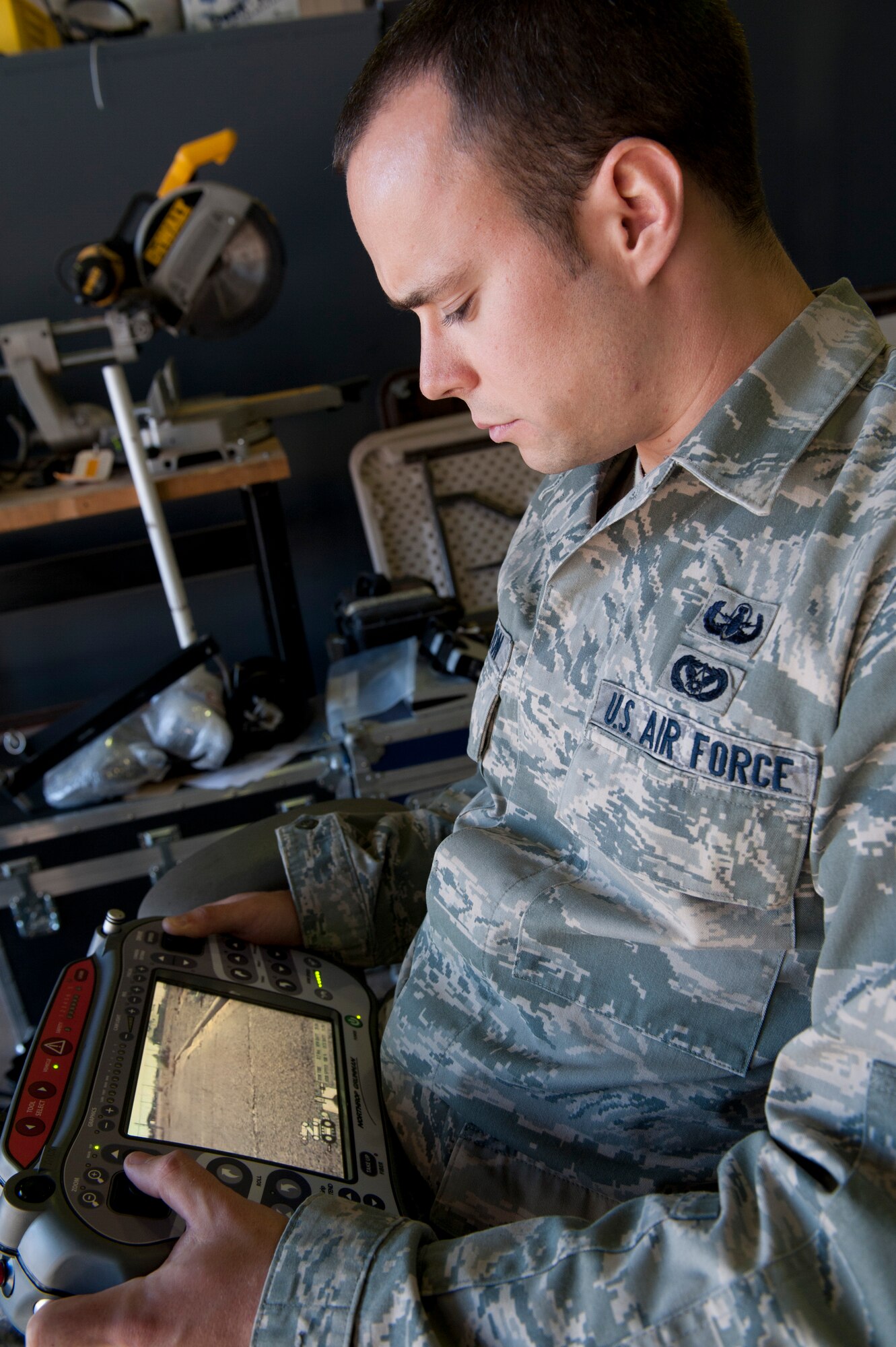 HOLLOMAN AIR FORCE BASE, N.M. -- U.S. Air Force Senior Airman Brook Hamilton, 49th Civil Engineer Squadron Explosive Ordnance Disposal journeyman, uses a control unit to guide a ANDROS HD-1 robot during a local training mission Nov. 30. EOD Airmen are tasked to render safe and dispose of any explosive hazards, to include conventional weapons; nuclear, biological, and chemical weapons; IEDs; and aircraft explosive hazards. (U.S. Air Force photo by Senior Airman Veronica Stamps/ Released)