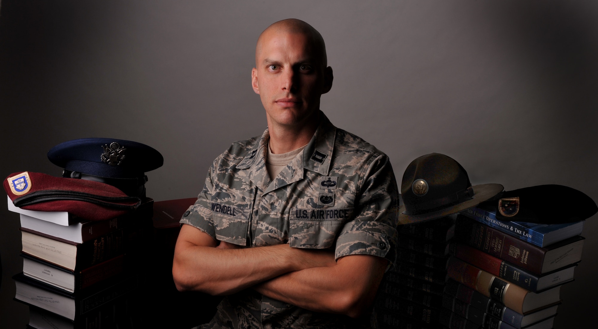 Capt. Joshua Wendell, 366th Fighter Wing assistant staff judge advocate, poses with his law books illustrating the amount of knowledge he has acquired over the years, Sept. 15, 2011, at Mountain Home Air Force Base, Idaho. Wendell was part of the Army Airborne Infantry for nine years and has been in his current position with the Air Force for two years. (U.S. Air Force photo by Airman 1st Class Heather Hayward)