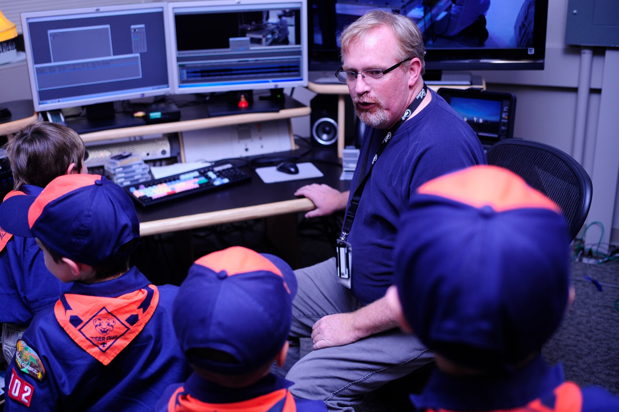 VANDENBERG AIR FORCE BASE, Calif. -- Michael Stonecypher, a 30th Space Wing Public Affairs Office broadcaster, teaches Vandenberg Cub Scout Pack 102 about live broadcasts in the editing room during the scouts’ visit to the PA office here Wednesday, Feb. 1, 2012. Stonecypher showed how a broadcast is performed during launch operations. (U.S. Air Force photo/Staff Sgt. Andrew Satran) 
