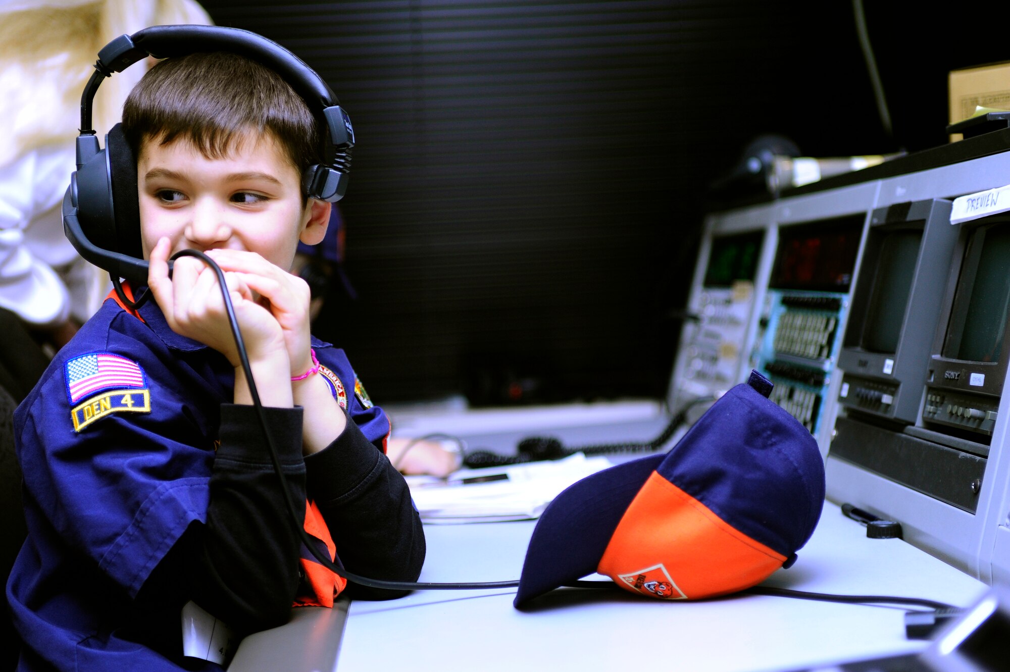 VANDENBERG AIR FORCE BASE, Calif. -- Tyler Havens, a Vandenberg Cub Scout, pretends to work a live broadcast in the television control room during his Cub Scout pack’s visit to the 30th Space Wing Public Affairs Office here Wednesday, Feb. 1, 2012. The scouts learned about the PA office mission to earn their news and media merit badges. (U.S. Air Force photo/Staff Sgt. Andrew Satran) 
