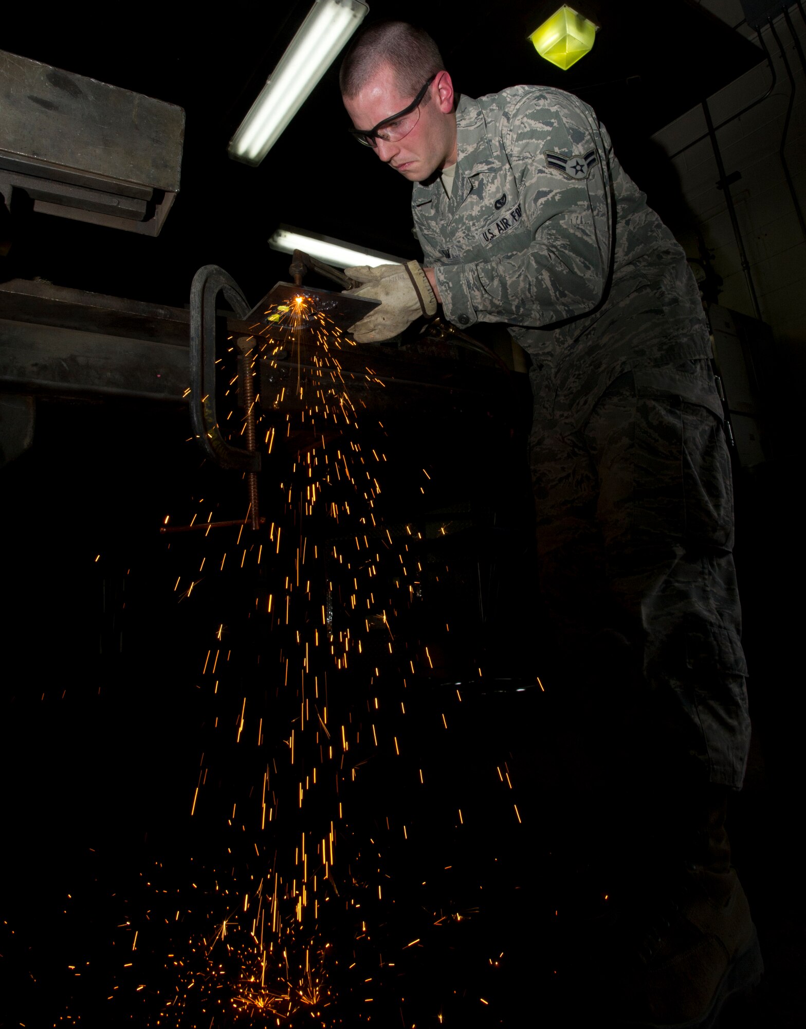 Airman 1st Class Kevin Dunham, 22nd Civil Engineer Squadron structures journeyman, cuts a stencil with a blow torch Jan. 31, 2012, McConnell Air Force Base, Kan. The Binghamton, N.Y. native also supports McConnell through regular maintenance of its facilities. (U.S. Air Force photo/Airman 1st Class Armando A. Schwier-Morales)