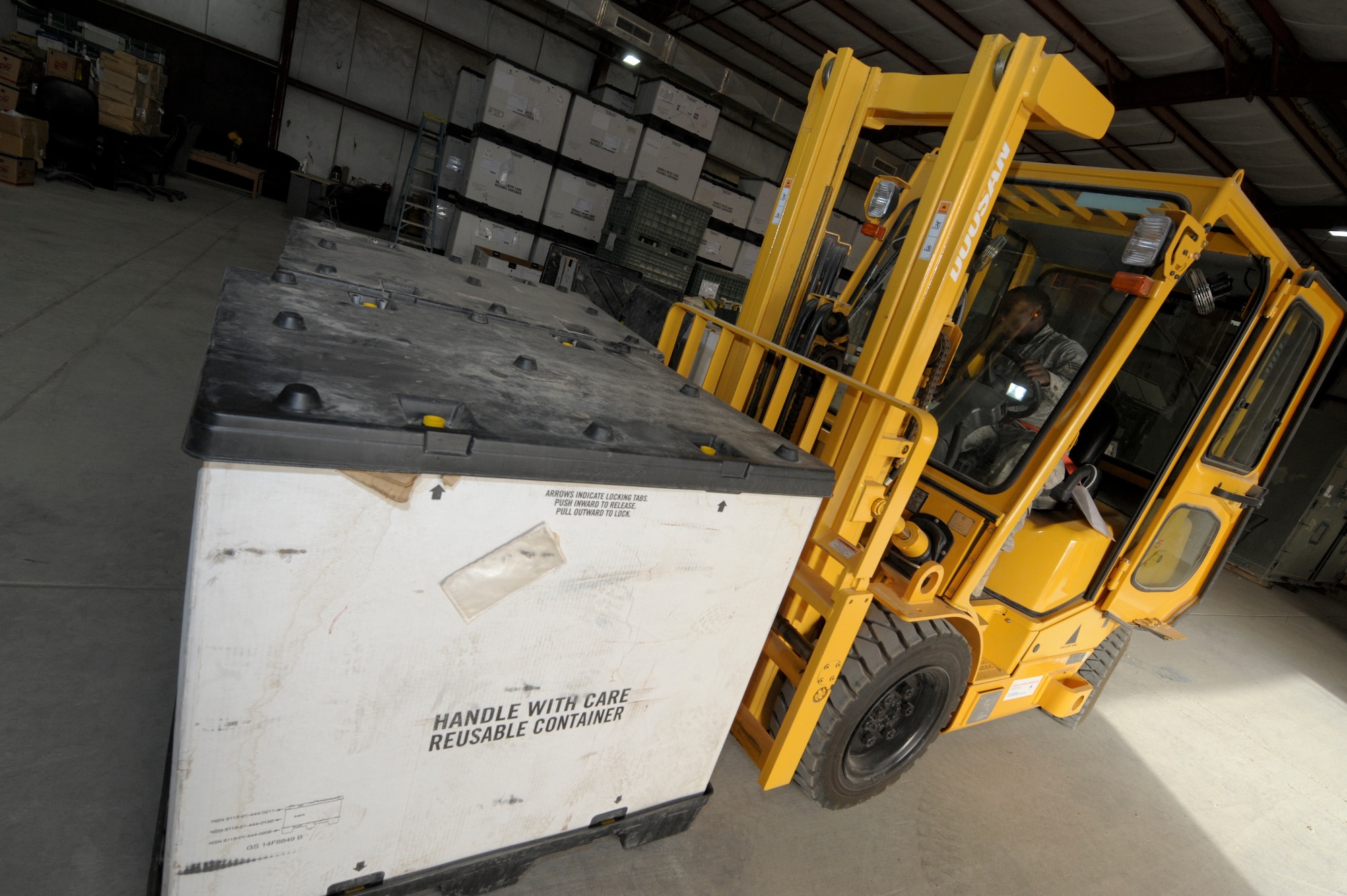 Senior Airman Tyree Mabson, 332nd Expeditionary Logistics Readiness supply flight, uses a forklift to transport parts at an undisclosed location in Southwest Asia, Feb. 2, 2012. The supply flight receives 300 to 400 pounds of supplies every day. Mabson is deployed from Joint Base McGuire-Dix-Lakehurst, N.J., and is a native of Freehold, N.J.(U.S. Air Force photo by Staff Sgt. Joshua J. Garcia/Released)