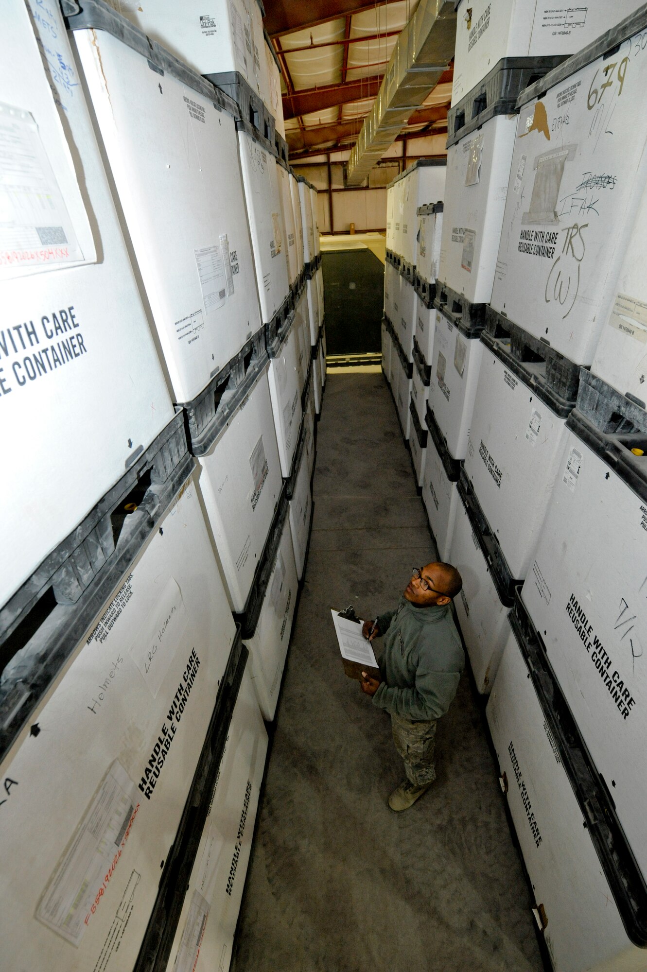 Staff Sgt. Aaron Prather, 332nd Expeditionary Logistics Readiness Squadron supply flight, completes an inventory for stored Individual Body Armor in the supply warehouse at an undisclosed location in Southwest Asia, Feb. 2, 2012. An IBA inventory is performed monthly to ensure the supply flight has enough for issue. Prather is deployed from Scott Air Force Base, Ill., and is a native of Paducah, Ky. (U.S. Air Force photo by Staff Sgt. Joshua J. Garcia/Released)