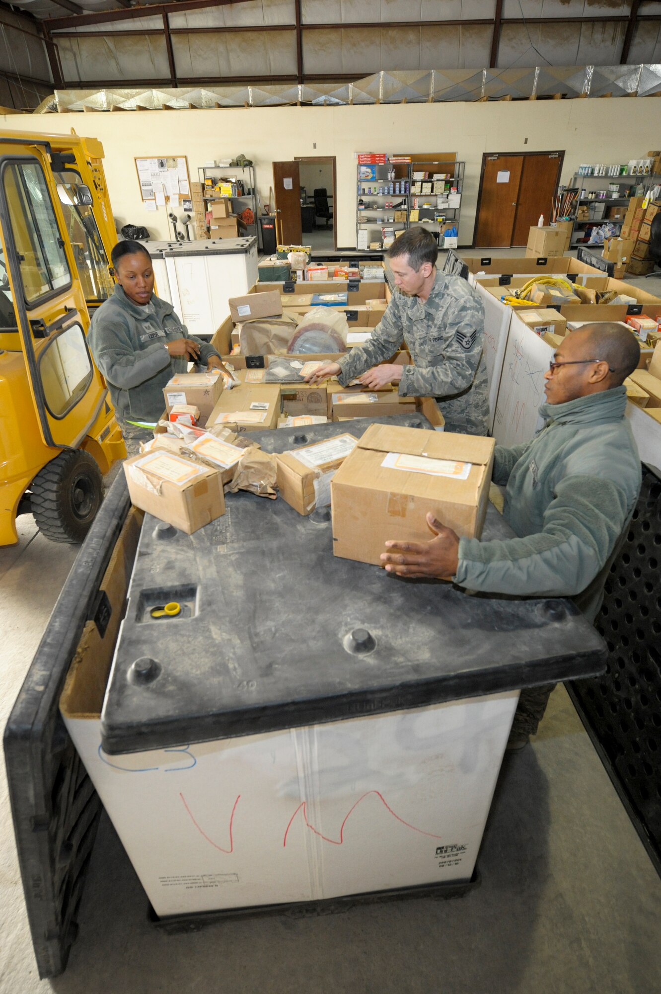 Members of the 332nd Expeditionary Logistics Readiness Squadron supply flight, pack vehicle parts into a tri-wall box at an undisclosed location in Southwest Asia, Feb. 2, 2012. The parts are packed for permanent storage until they are needed for maintenance use. The supply flight maintains accountability for all vehicle and aircraft parts held in storage. (U.S. Air Force photo by Staff Sgt. Joshua J. Garcia/Released)