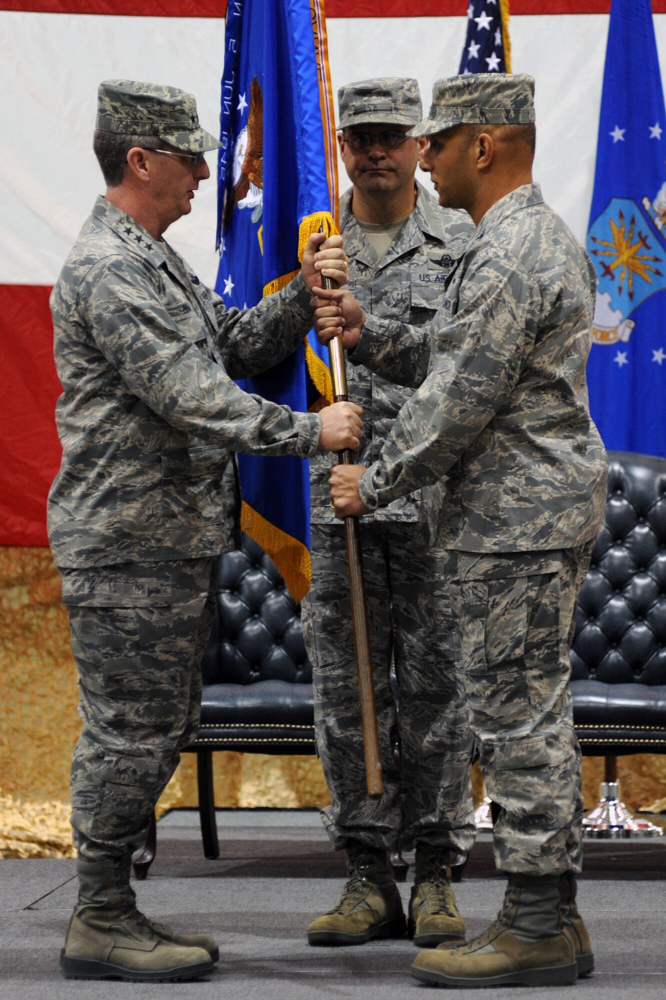 Col. Brian Robinson (right), the incoming 19th Airlift Wing commander, accepts the guidon from Lt. Gen. Mark F.  Ramsay, 18th Air Force commander, during a change of command ceremony at Little Rock Air Force Base, Ark. The 19th AW is the host unit to more than 90 C-130 aircraft, the world’s largest C-130 base. (U.S. Air Force photo by Airman 1st Class Rusty Frank)