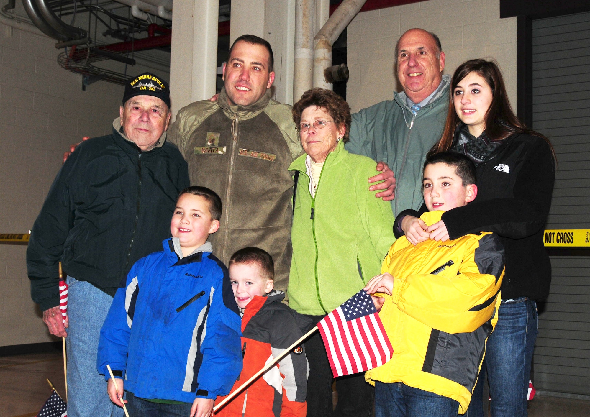 The family of Master Sgt. Chris Divita of the 103rd Security Forces Squadron offers an enthusiastic welcome home from Afghanistan at Bradley Air National Guard Base, East Granby, Conn., Jan. 30, 2012. Divita and his troops performed security and patrol operations at Bagram Airfield during their six-month deployment. (U.S. Air Force photo by Tech. Sgt. Erin McNamara\RELEASED)