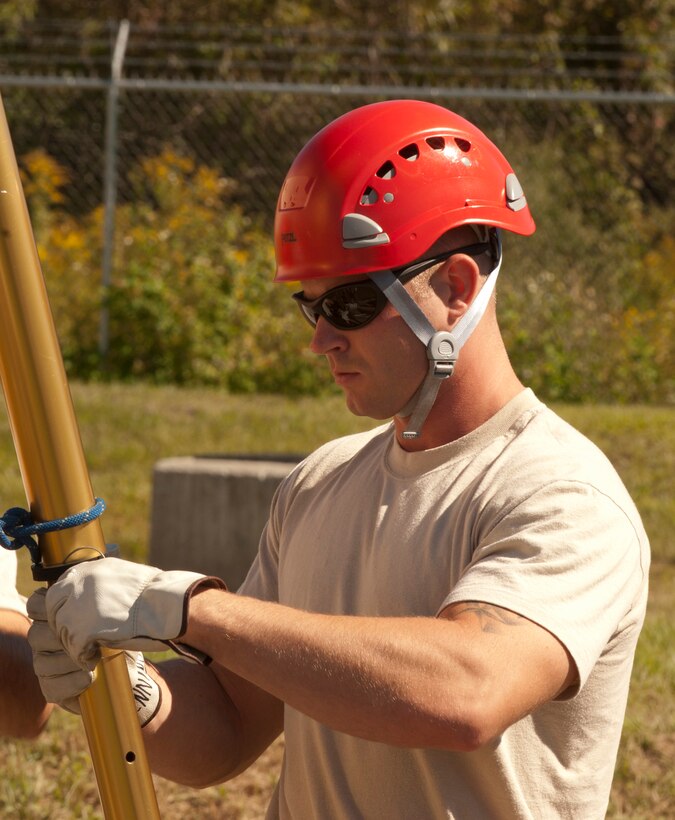 Senior Airman Brandon Jennings, 125th Fighter Wing Firefighter, helps set up a tripod in order to recover a simulated casualty in a confined space. Members of the 125th Fire Department performed the confined spaces rescue in conjunction with the125th Fighter Wing's Unit Compliance Inspection, October 22, 2011, Jacksonville, Fla . (USAF Photo by MSgt. Shelley Gill)