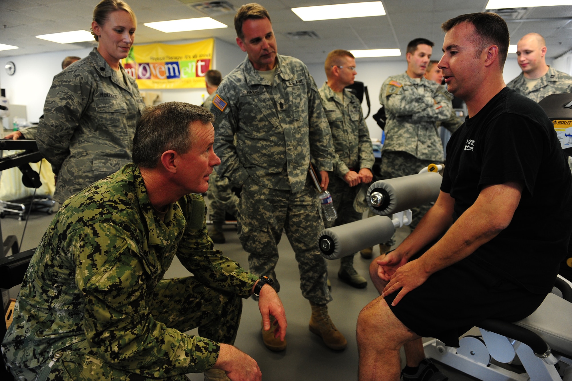 U.S. Navy Adm. William McRaven, commander of U.S. Special Operations Command, tests the leg and arm strength of Staff Sgt. Christopher Curtis CV-22 flight engineer of the 8th Special Operations Squadron, at 1st Special Operations Medical Group physical and occupational therapy clinic Jan. 30, 2012, on Hurlburt Field, Fla. The admiral was present for Curtis? emergency surgery down range after an aircraft mishap. (U.S. Air Force photo/Senior Airman Eboni Reams)


