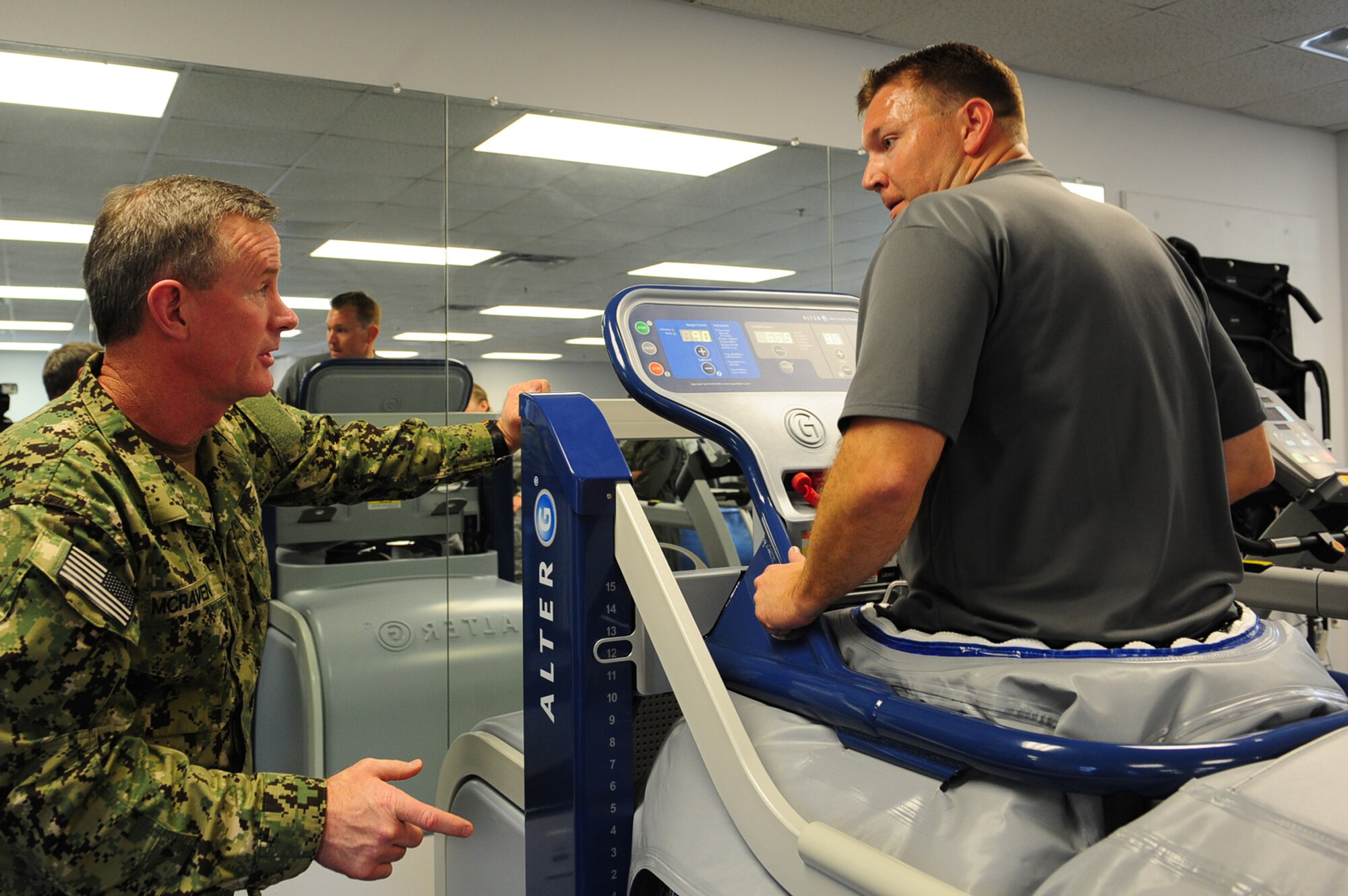 U.S. Navy Adm. William McRaven, commander of U.S. Special Operations Command, visits with Capt. Ron Knight, chief  of the 1st Special Operation Wing Safety while using the anti-gravity treadmill Jan. 30, 2012, at the 1st Special Operations Medical Group physical and occupational therapy clinic on Hurlburt Field, Fla. (U.S. Air Force photo/Senior Airman Eboni Reams)

