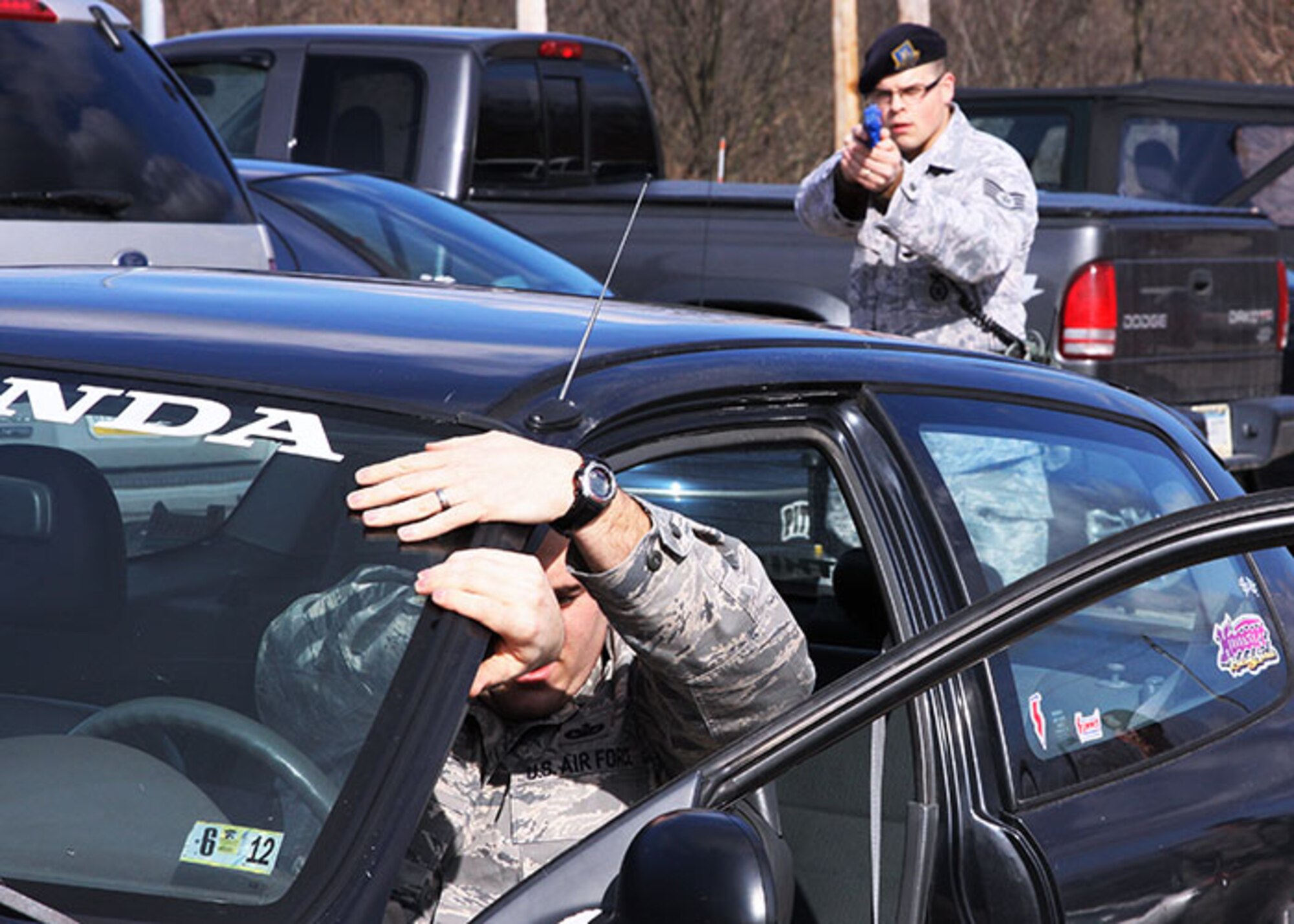 Tech. Sgt. James T. Hindinger and Staff Sgt. David M. Corob, attached to 911th Security Forces Squadron, participate in a training exercise held at the base on Feb. 1, 2012. This staged event concentrates on maintaining officer awareness while dealing with potential threats caused by traffic violators and their passengers. (U.S. Air Force photo by Tech. Sgt. Ralph Van Houtem/ Released)